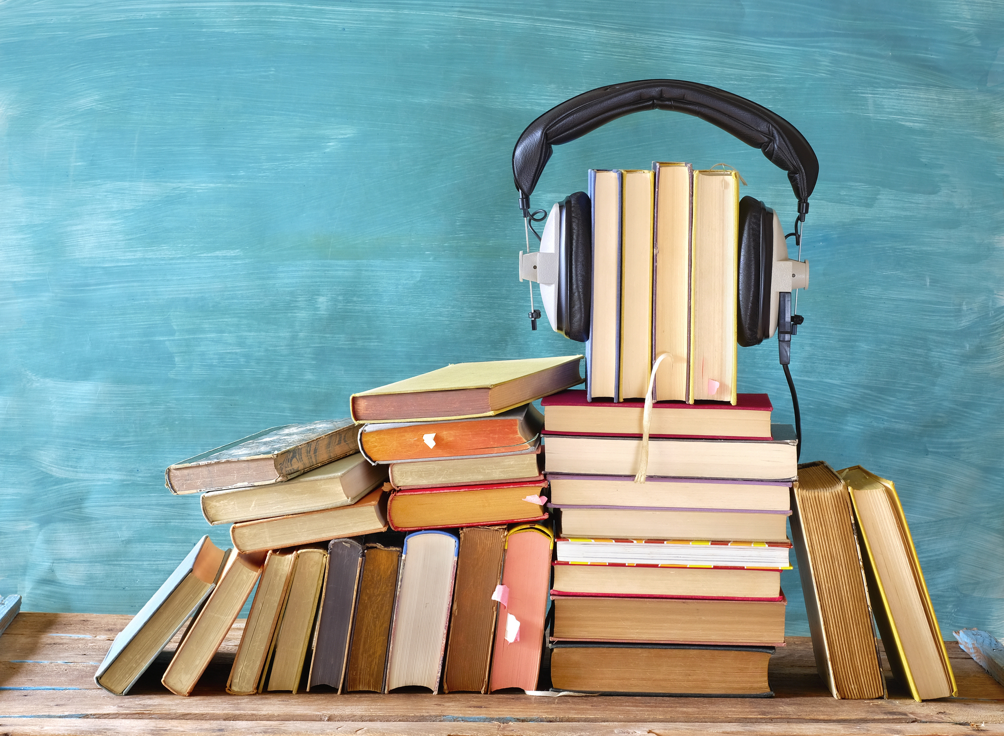 <p>Large heap of books and heaphones, audio books concept, entertainment and education during corona lockdown</p>