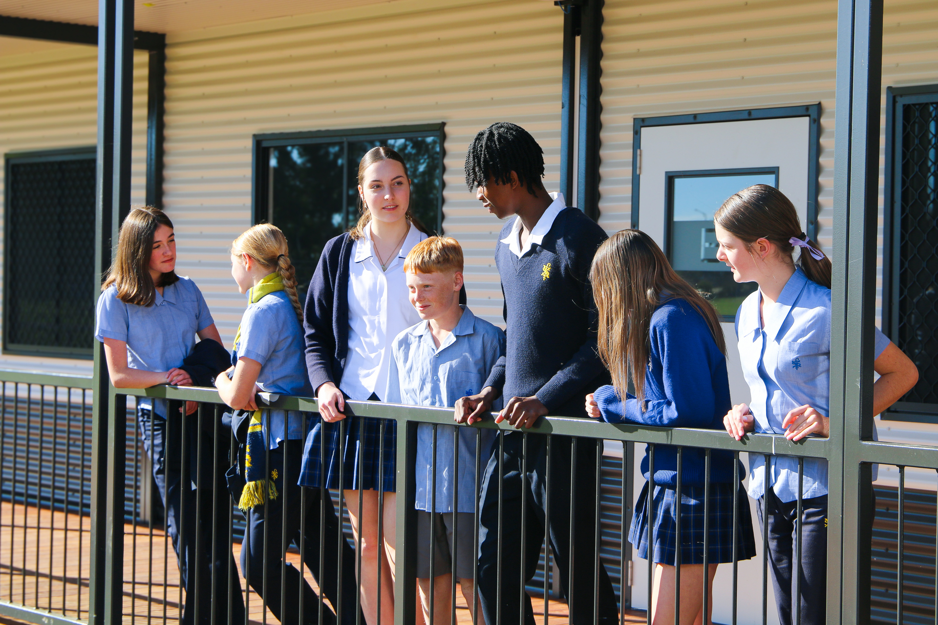 A group of students standing outside a classroom