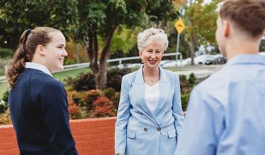 The SFX Principal talking to two students